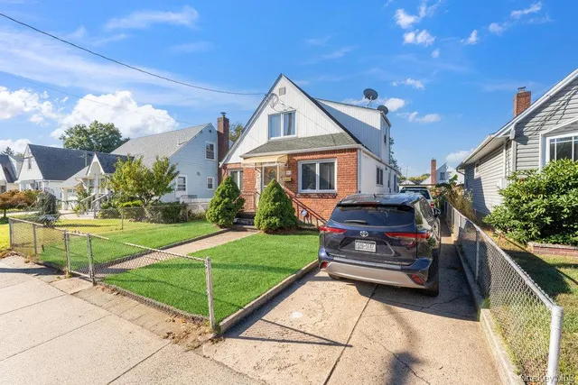 a house view with a sitting space and garden