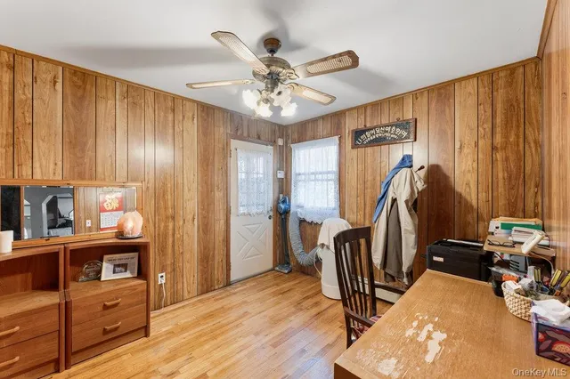 a view of a hallway with wooden floor and windows