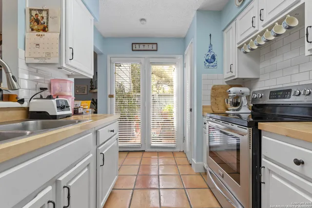a kitchen with stainless steel appliances granite countertop a refrigerator and a stove