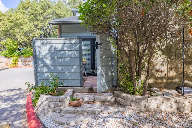 a backyard of a house with table and chairs