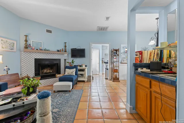 a kitchen with stainless steel appliances kitchen island granite countertop a refrigerator and cabinets
