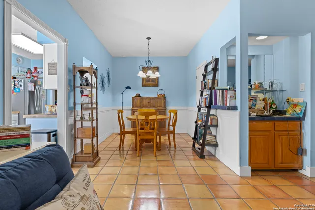 a dining room with furniture and a book shelf