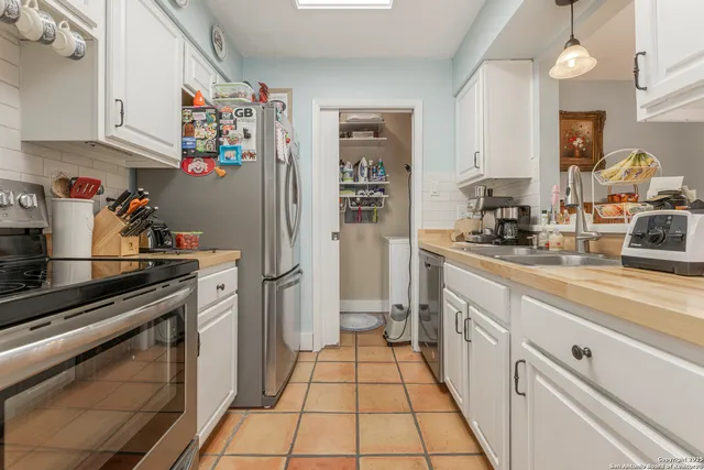 a kitchen with stainless steel appliances granite countertop a stove and a sink