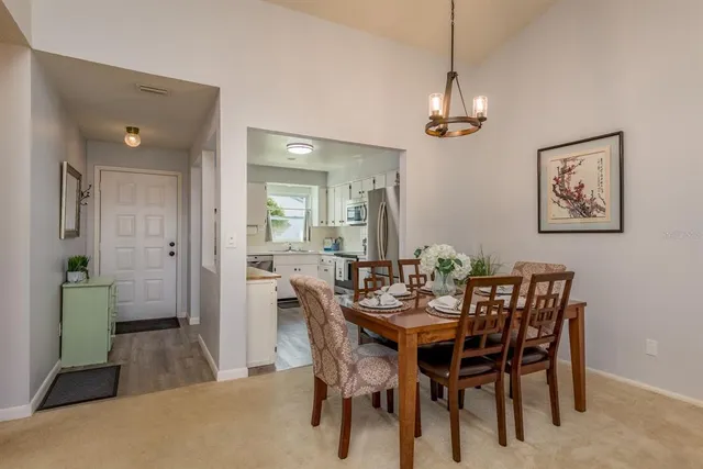 a spacious bedroom with a bed and a chandelier