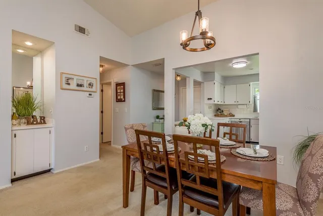 a bedroom with a large bed and a flat tv screen on dresser