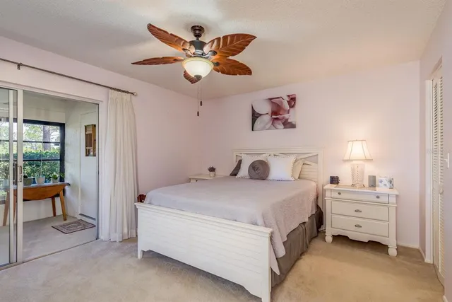 a living room with furniture tv and a floor to ceiling window