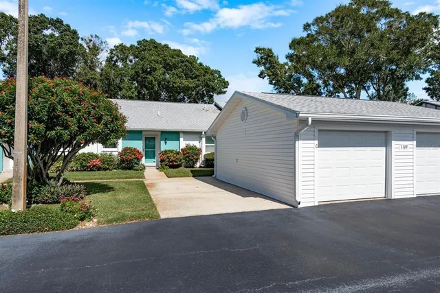a view of a house with a yard and garage