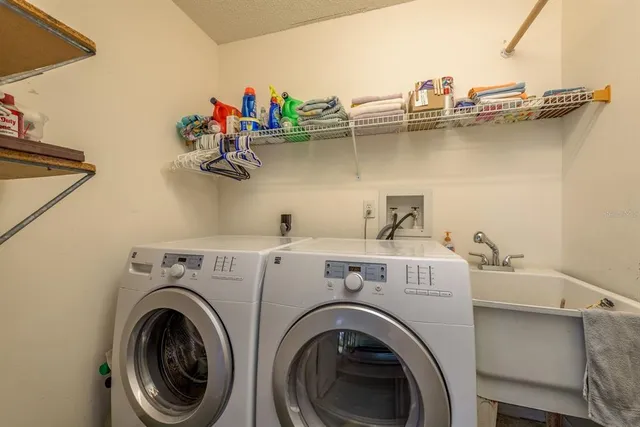 an aerial view of a city with lots of residential buildings ocean and mountain view