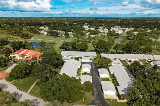 a view of a swimming pool with a patio and a yard