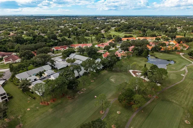 a view of a table and chairs in backyard of the house
