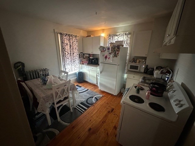 55 Cottage Street Hudson, MA 01749 - Photo 7 of 11 a view of a dining room with furniture and a chandelier
