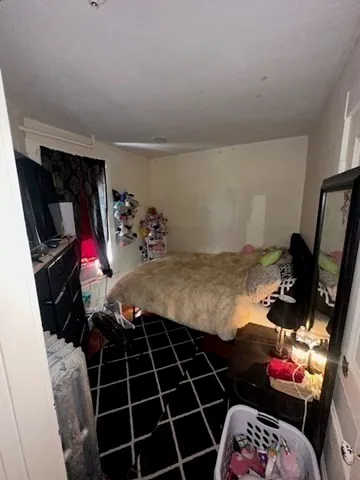 a bedroom with a bed and a mirror