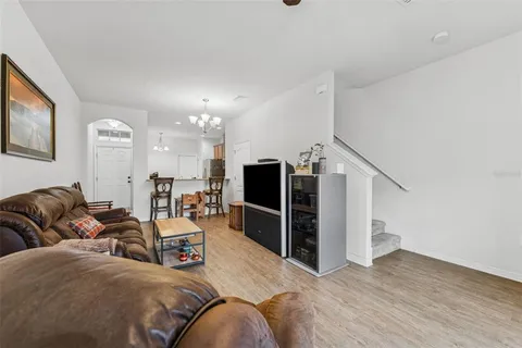 a living room with furniture and a chandelier