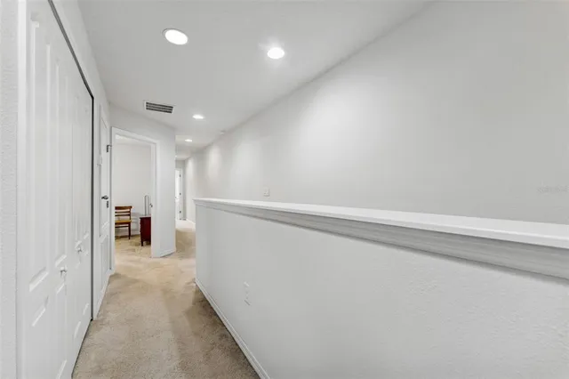 a bedroom with a bed and a large mirror with a dresser