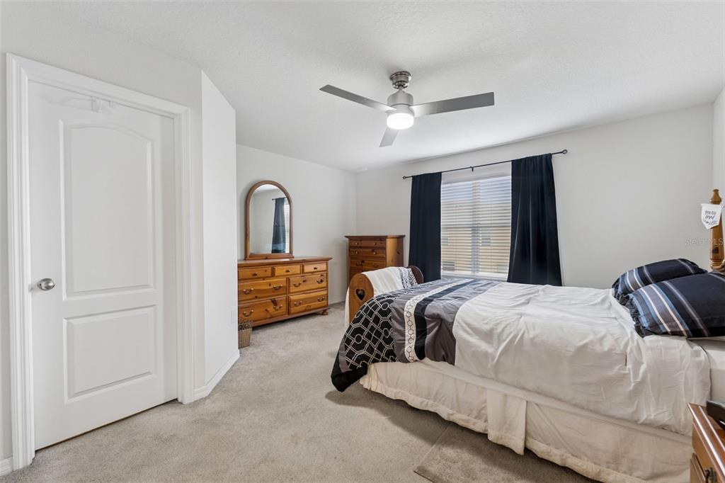 2129 Lennox Dale Lane Brandon, FL 33510 - Photo 17 of 38 a bedroom with a bed and a large mirror with a dresser