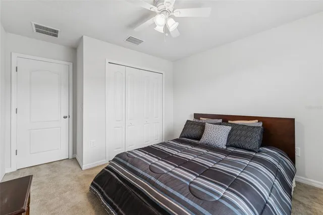a bathroom with a granite countertop sink a toilet and a mirror