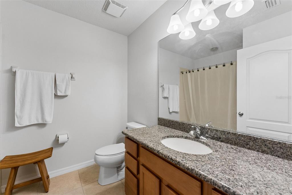 2129 Lennox Dale Lane Brandon, FL 33510 - Photo 23 of 38 a bathroom with a granite countertop sink a toilet and a mirror