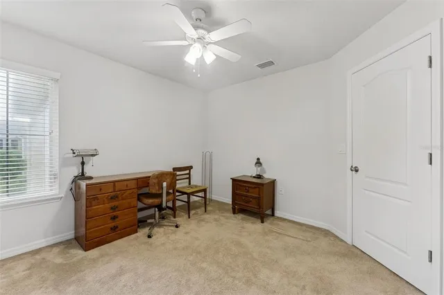 a view of a livingroom with a ceiling fan