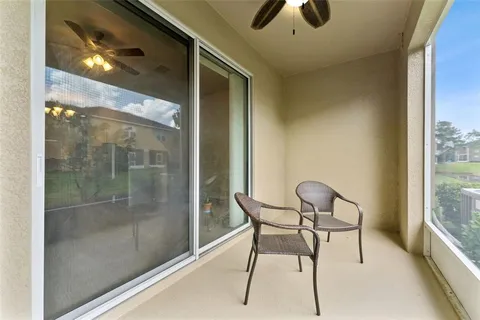 a view of a porch with furniture and a yard