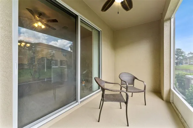 a view of a porch with furniture and a yard