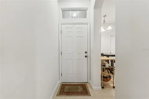 a kitchen with stainless steel appliances granite countertop a table chairs microwave and sink