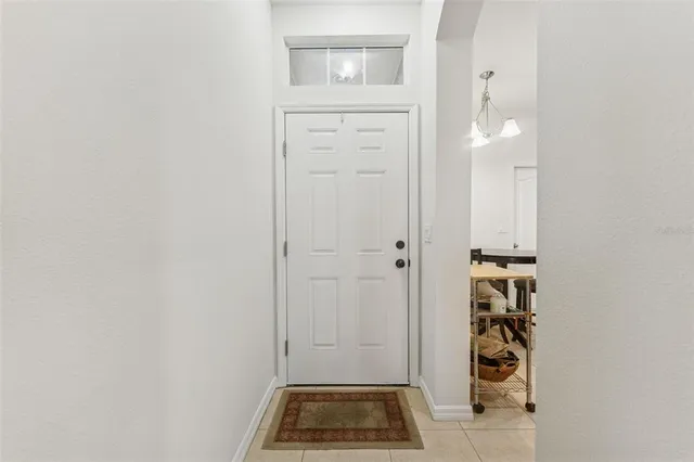 a kitchen with stainless steel appliances granite countertop a table chairs microwave and sink