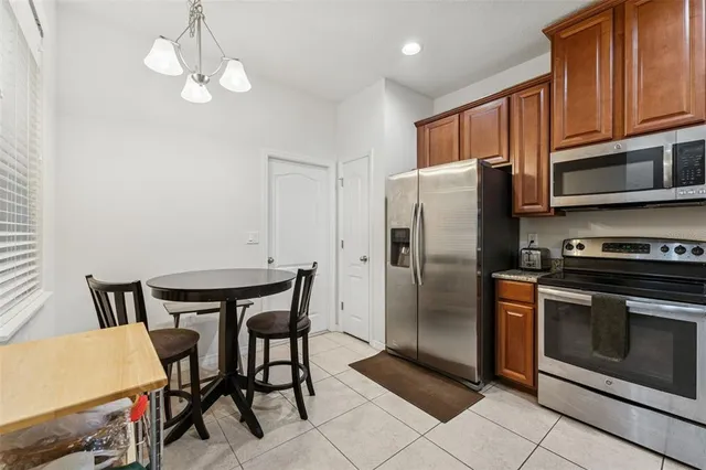 a view of a dining room with furniture and chandelier