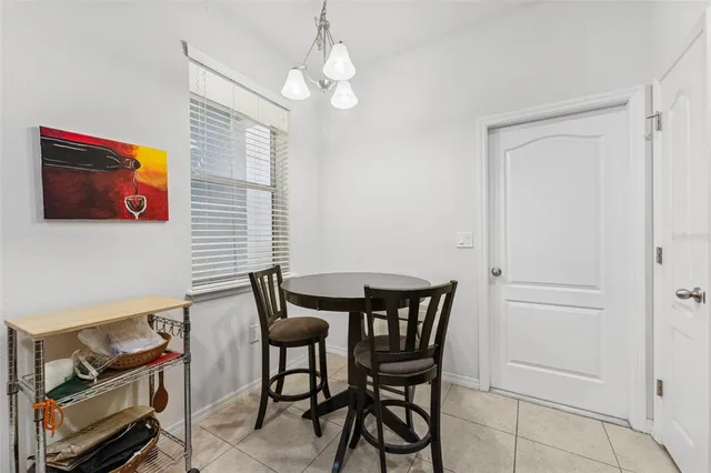a kitchen with granite countertop a refrigerator stove top oven and sink