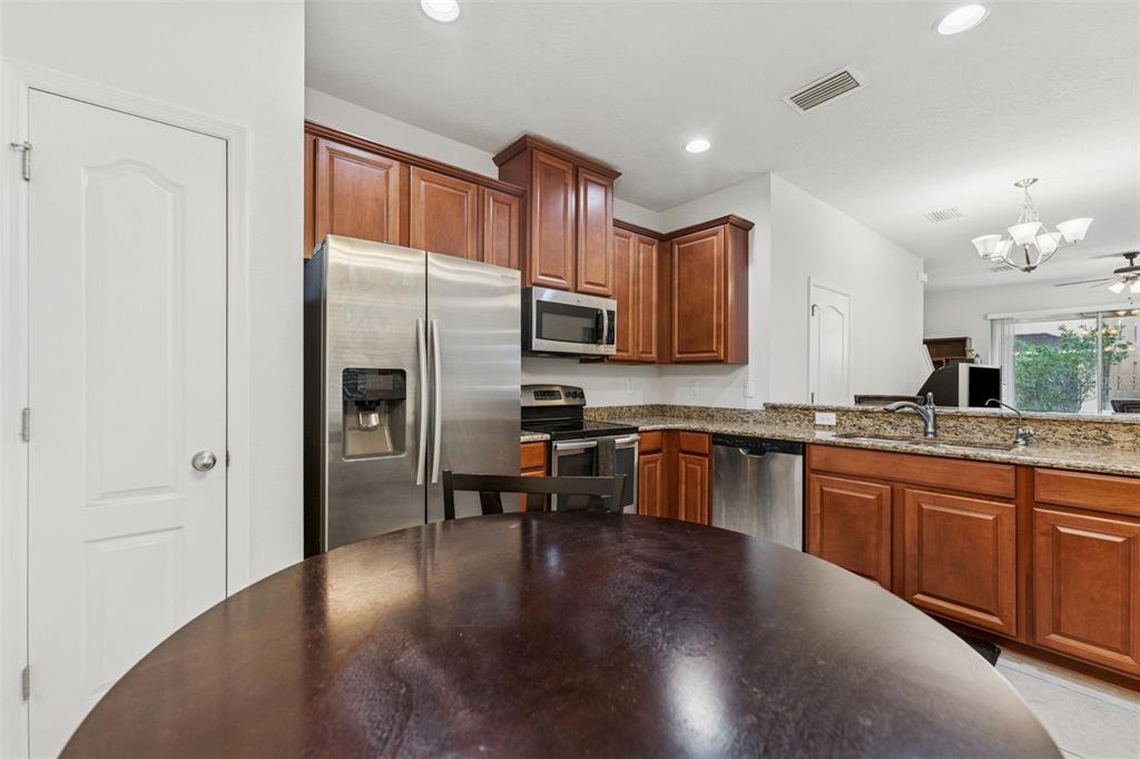 2129 Lennox Dale Lane Brandon, FL 33510 - Photo 10 of 38 a kitchen with granite countertop a refrigerator stove top oven and sink