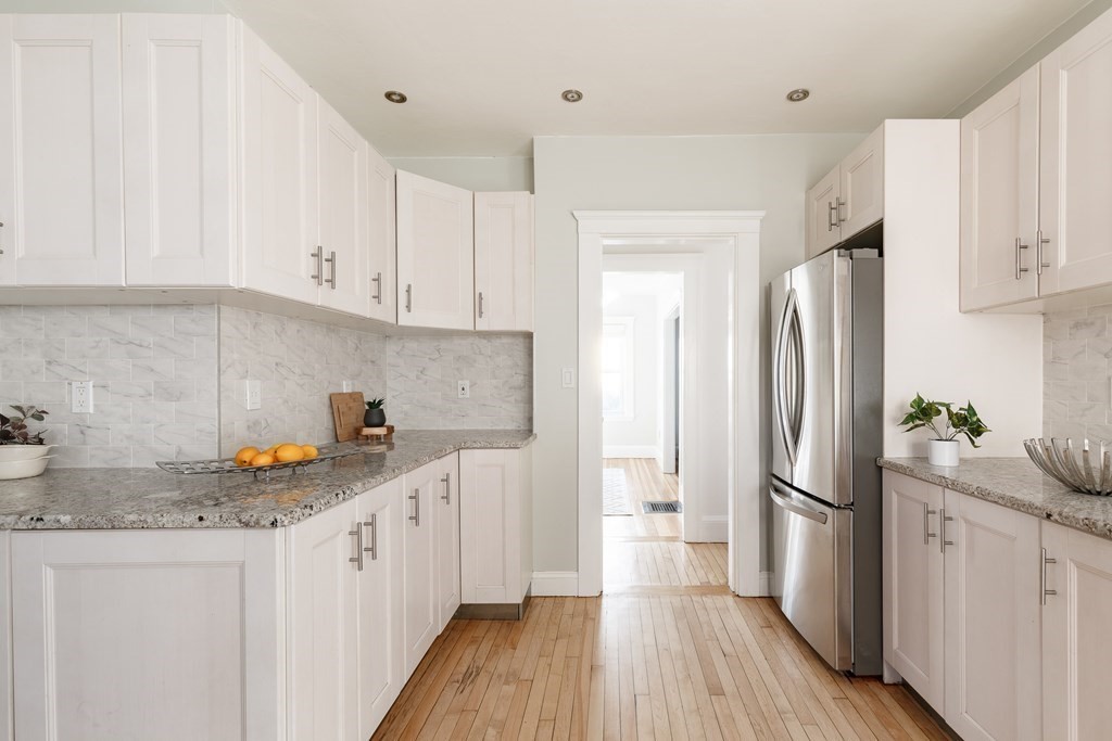19 Riverside Street Needham, MA 02494 - Photo 8 of 18 a kitchen with stainless steel appliances granite countertop a refrigerator sink and white cabinets