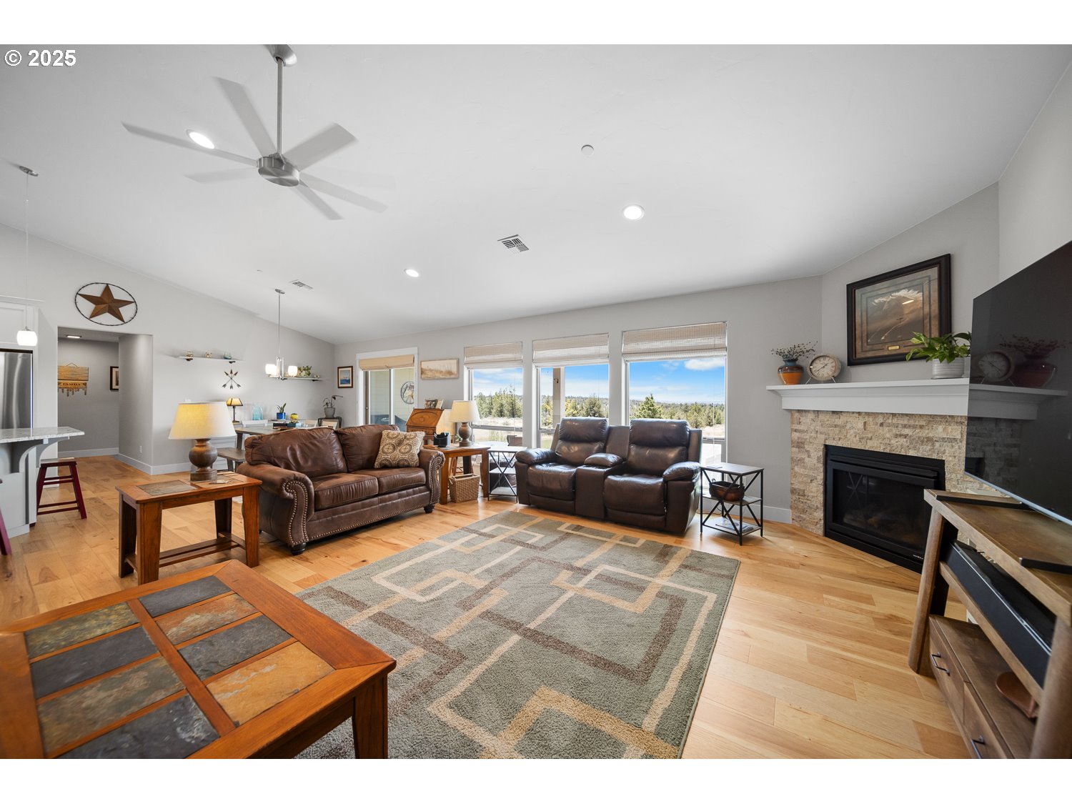 4416 Southeast Laredo Road Prineville, OR 97754 - Photo 12 of 36 a living room with furniture a fireplace and a flat screen tv