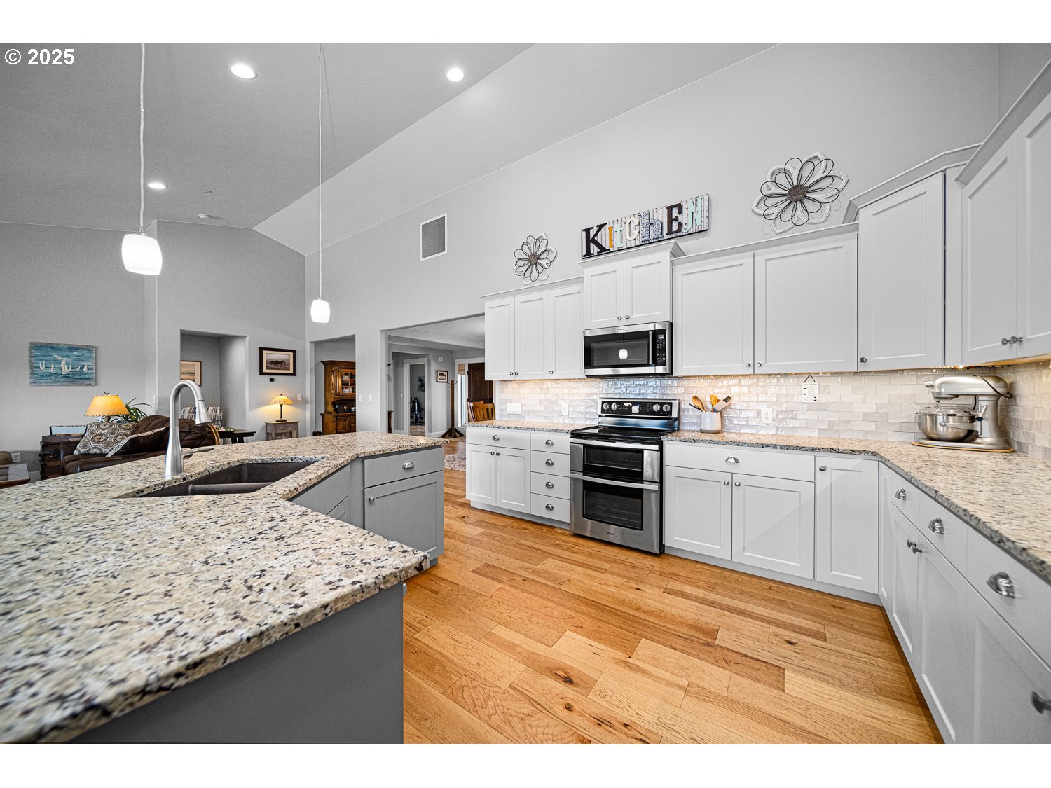 4416 Southeast Laredo Road Prineville, OR 97754 - Photo 17 of 36 a kitchen with stainless steel appliances granite countertop a sink stove oven and white cabinets