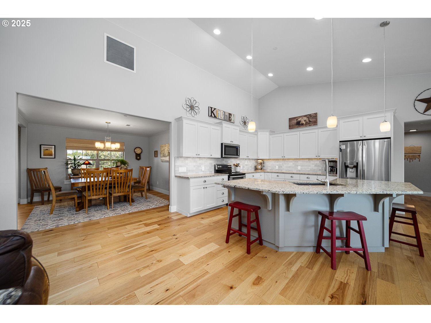 4416 Southeast Laredo Road Prineville, OR 97754 - Photo 19 of 36 a kitchen with stainless steel appliances kitchen island granite countertop lots of counter top space and furniture