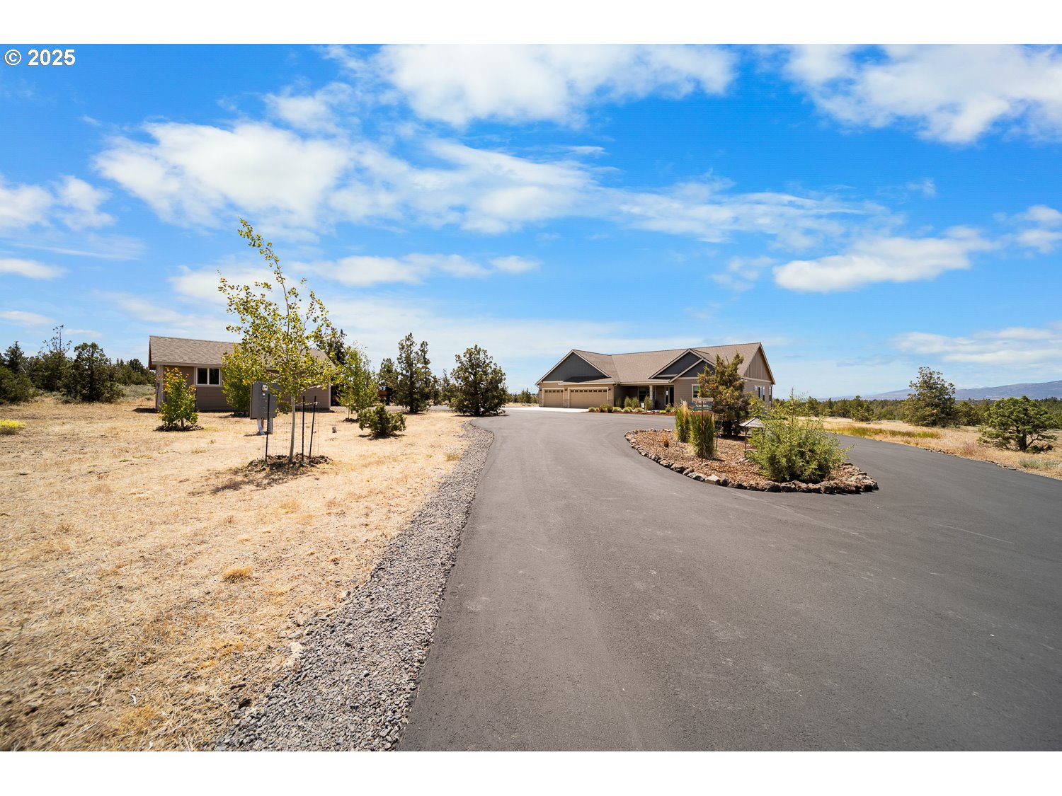 4416 Southeast Laredo Road Prineville, OR 97754 - Photo 2 of 36 a view of a road with houses