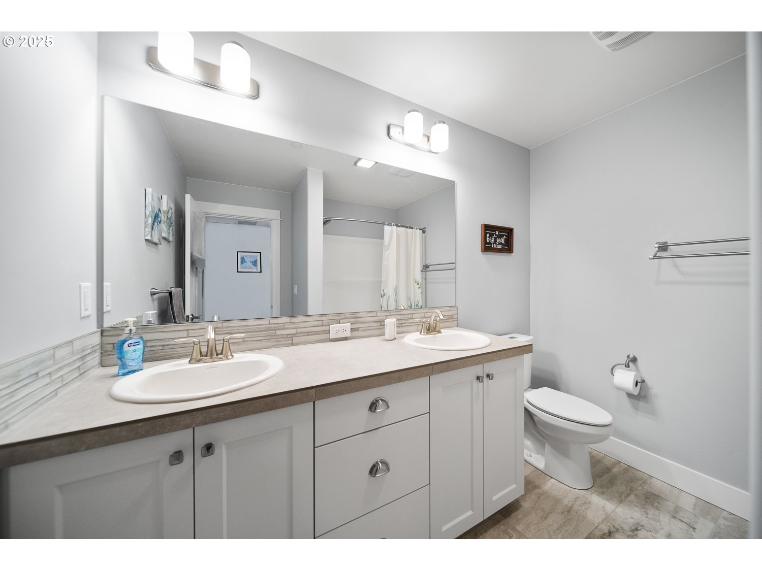 4416 Southeast Laredo Road Prineville, OR 97754 - Photo 29 of 36 a bathroom with a granite countertop toilet a double sink and a mirror