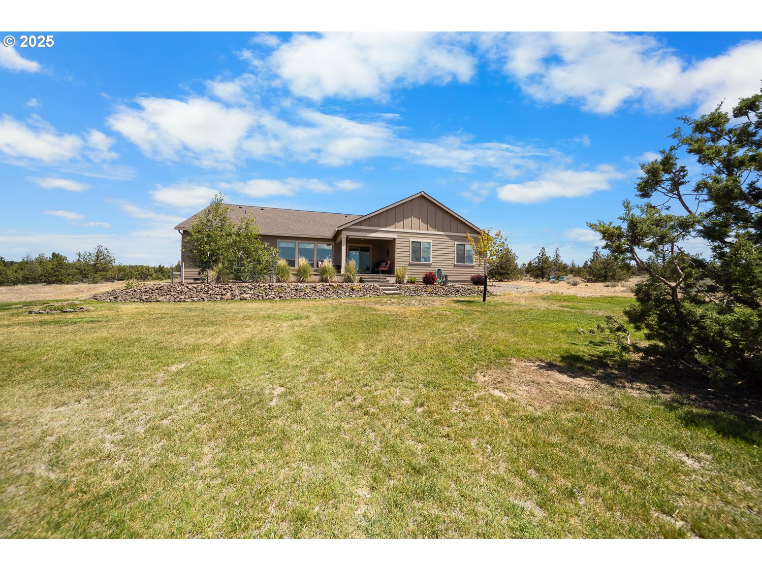 4416 Southeast Laredo Road Prineville, OR 97754 - Photo 36 of 36 a view of a yard with a house in the background