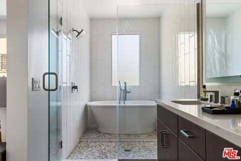 a white bath tub sitting next to a white sink