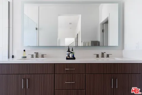 a bathroom with a double vanity sink and mirror