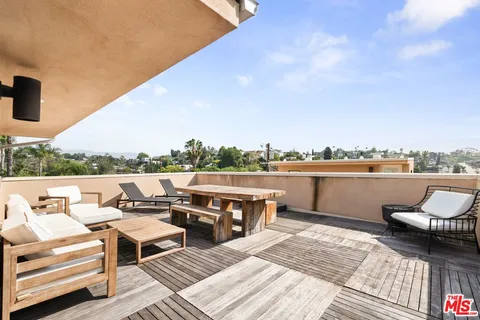 a terrace of a house with outdoor seating