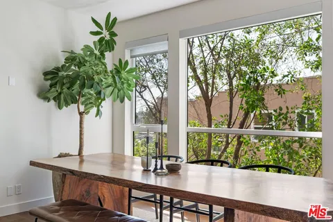 a dining room with furniture window and wooden floor