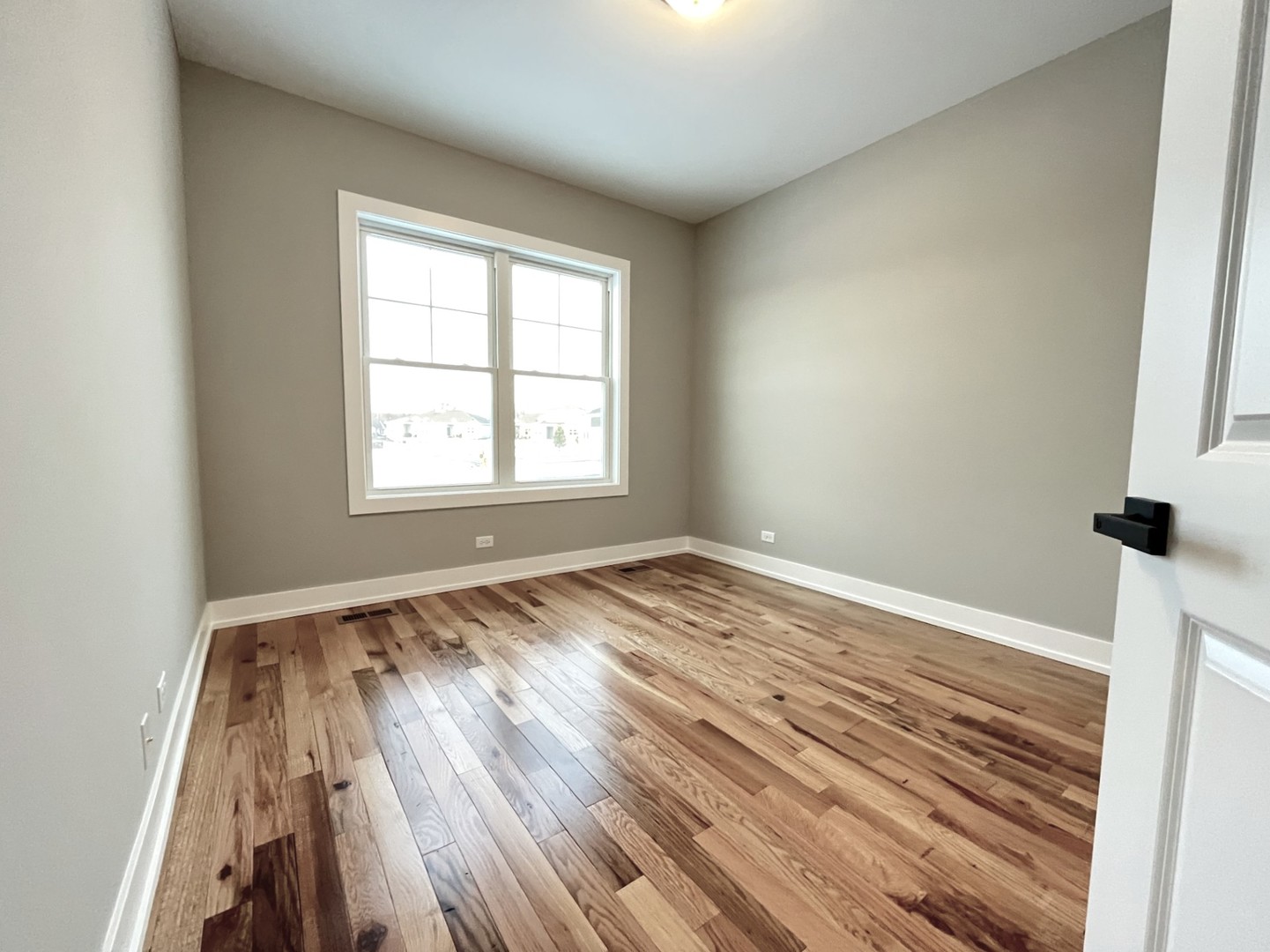 970 Partridge Circle Marengo, IL 60152 - Photo 12 of 17 an empty room with wooden floor and windows