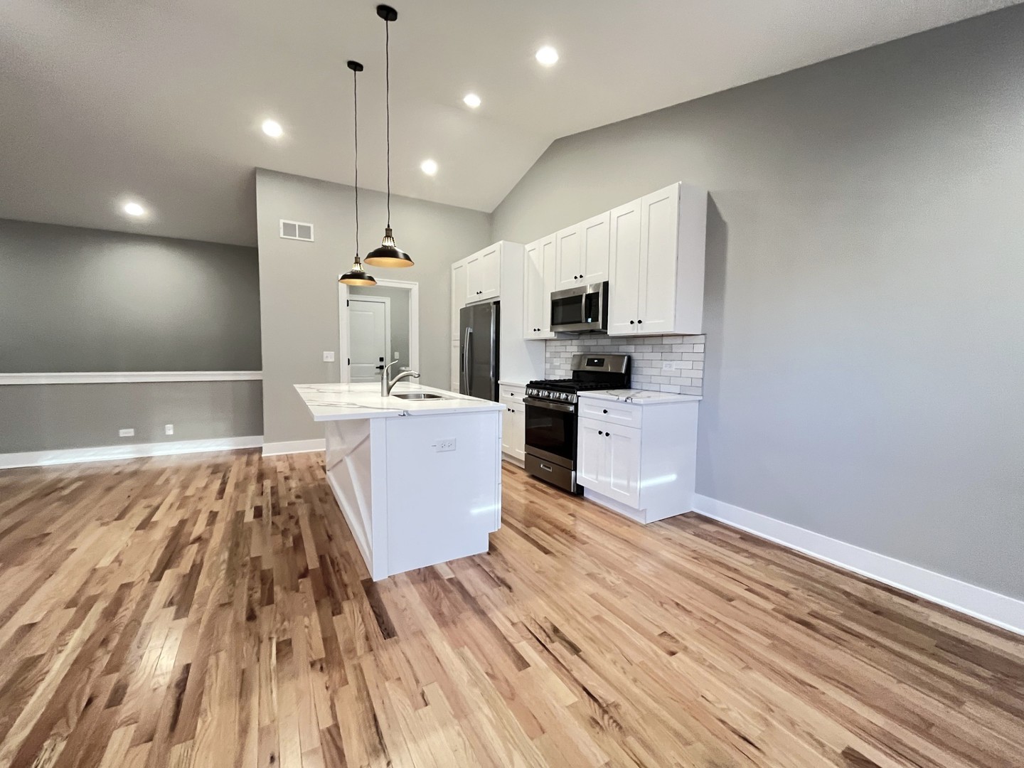 970 Partridge Circle Marengo, IL 60152 - Photo 4 of 17 a large kitchen with kitchen island a sink dishwasher a stove and a microwave oven with wooden floor
