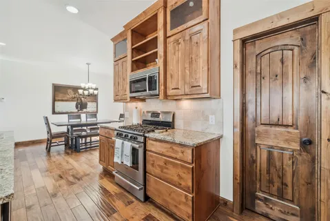 a kitchen with stainless steel appliances granite countertop a stove and a refrigerator