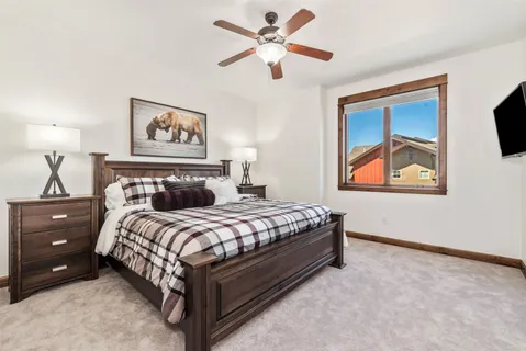 a bedroom with a bed and a painting on the wall