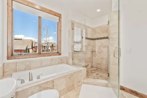 a bathroom with a granite countertop tub sink and a shower