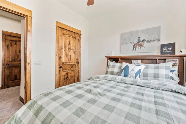 a bedroom with a bed and painting on the wall