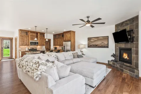 a living room with furniture fireplace and flat screen tv