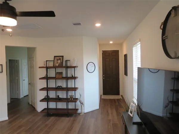 a view of a room with wooden floor and window