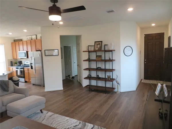 a living room with furniture wooden floor and window