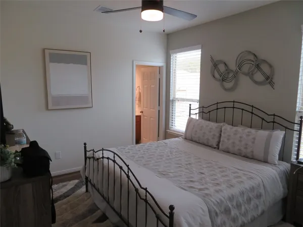 a bedroom with a bed and a chandelier